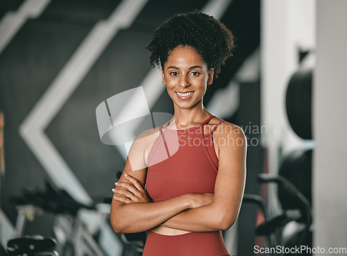 Image of Black woman, fitness and coach with arms crossed and smile for training, exercise or workout at the gym. Portrait of a confident African American female sports instructor with vision for healthy body