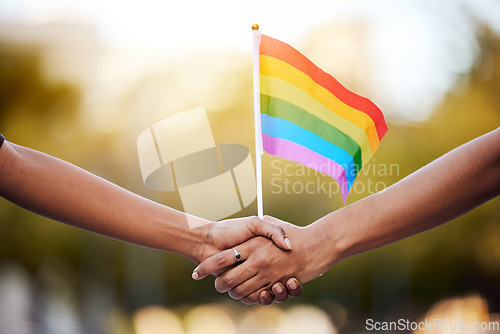 Image of LGBTQ rainbow, flag and couple holding hands for gay pride, lesbian support or human rights activist. Transgender, love and African black people together for equality, partnership and LGBT community