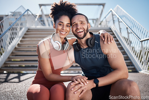 Image of Couple, fitness and smile with hug in the city for break from running exercise, training or workout on steps. Portrait of happy man and woman smiling in relax for healthy cardio exercising outside