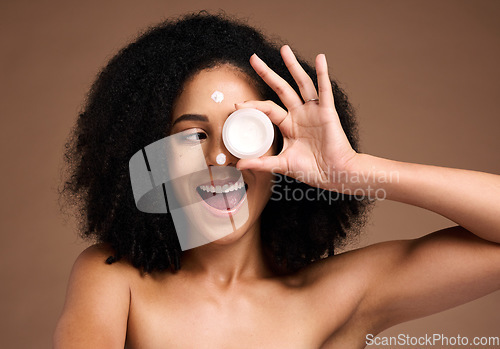 Image of Cream container, skincare and black woman in studio happy for facial product, natural cosmetics or beauty mockup. African model with wow face for serum, collagen or dermatology sunscreen in her hand