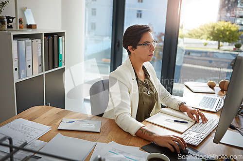 Image of Office, planning and business woman with computer typing online documents, website research and writing email. Corporate networking, and busy female employee at desk with focus, strategy and ideas