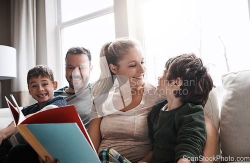 Image of Love, parents and brothers with a book, sofa and bonding on weekend, loving and learning together. Family, mother and father with boys, child development and reading on couch in living room and relax