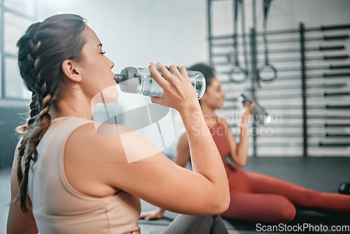 Image of Fitness, gym and relax friends drinking water for sports thirst hydration, performance workout or exercise running. Athlete health, fatigue and tired women with liquid bottle drink after training