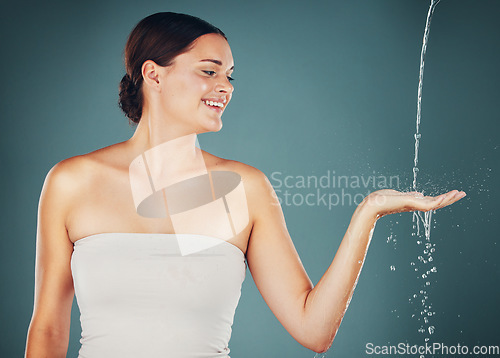 Image of Woman, water and washing hand, smile and happy isolated on studio background, hygiene and skincare with beauty. Health, wellness and splash, natural cosmetics and body, shower and cleaning hands