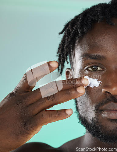 Image of Black man, hands and face for skincare moisturizer, lotion or cream for facial glow or treatment against studio background. African American male, person or guy applying creme for smooth or soft skin