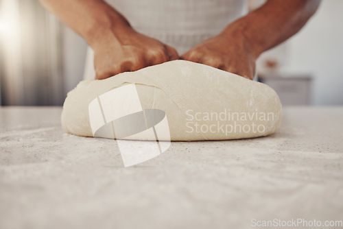 Image of Man hands and cook kneading dough for baking preparation work and process at culinary counter. Restaurant chef and worker in professional kitchen preparing wheat bread or pizza recipe.