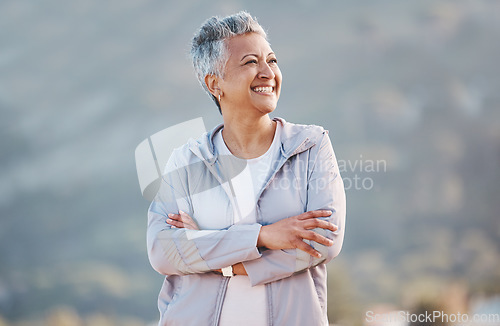 Image of Senior woman, fitness exercise and relax outdoor for calm vision, freedom and sports workout in nature. Cardio lifestyle, elderly person and happy athlete thinking on mountain top with crossed arms