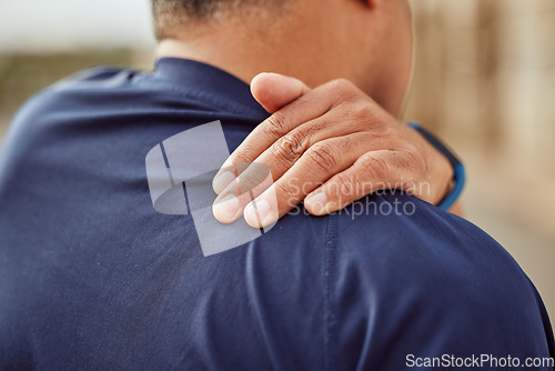 Image of Fitness, back pain and man with hand on shoulder muscle for support, massage and relief during exercise or workout. Health, sports training and wellness and painful sports injury with hands on back.