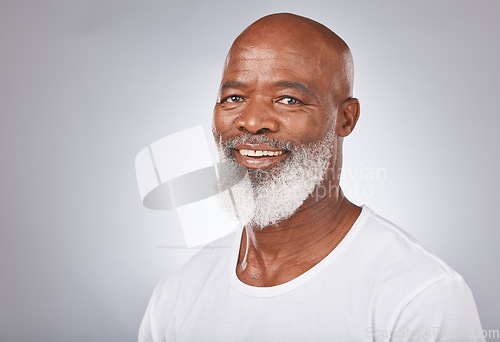 Image of Senior black man, face and self care with skincare, dermatology and cosmetics for clean, glow and fresh skin. Portrait of African male with a beard on grey studio background for beauty spa treatment