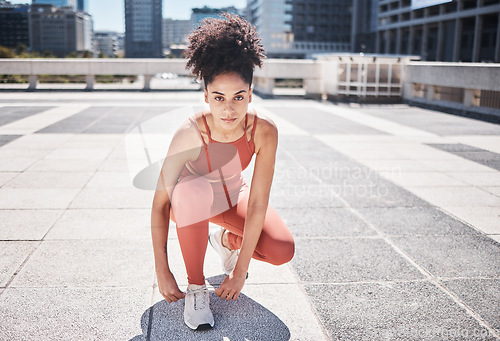 Image of Portrait, fitness and black woman tie shoes getting ready for training in city. Face, sports and female runner tying sneaker lace and preparing for workout jog, running or exercise outdoors on street