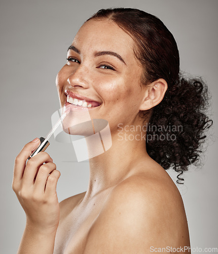 Image of Woman, lipstick and smile for makeup cosmetics, skincare or beauty against a grey studio background. Portrait of happy female smiling in satisfaction for lip, mouth and applying cosmetic treatment