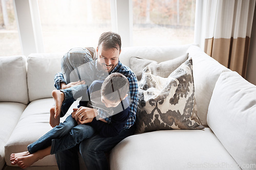 Image of Father, children and play together on sofa for bonding, relax fun and happiness energy in family home. Parent, happy kids and playful smile on couch in living room for love or funny quality time