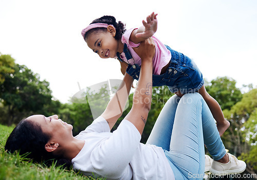 Image of Black family, park and flying with a mother and daughter having fun together while bonding on grass outdoor. Kids, love and nature with a woman and girl playing in a nature garden outside in summer