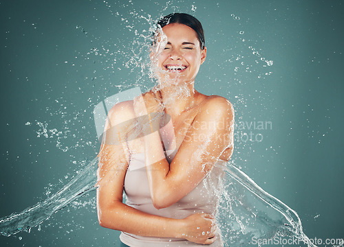 Image of Woman, water splash and cleaning for wellness, natural and body care on studio background. Female, girl and wet for shower, washing and liquid for hygiene, grooming routine and skincare on backdrop