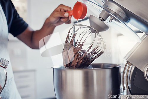 Image of Baking, food and man with a machine for mixing, cooking and preparing a cake with ingredients. Snack, meal and hands of a baker making a dessert with an appliance in the kitchen for a career