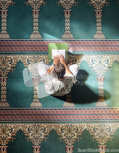 Image of Religion, quran and Muslim man reading for spiritual education, learning worship and faith during ramadan. Islam, holy and above of an Islamic person with a book in a mosque for studying prayer