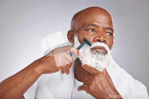 Image of Face, shaving cream and black man with razor on beard, skincare spa treatment on grey background. Health, mock up and facial hair, mature man morning shave routine with space for product placement.