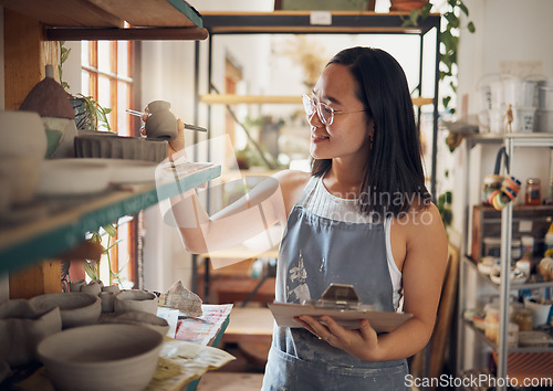 Image of Pottery, woman or small business owner with inventory, stock and product quality, management and production results. Art startup checklist, creative worker and asian designer check design on a shelf