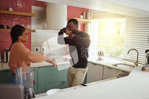 Image of Black couple, dancing and happy together in the kitchen for fun and happiness in a marriage with commitment. Man and woman dance to music while in the kitchen to celebrate their house or apartment