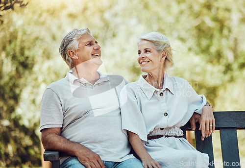 Image of Love, retirement and couple on bench in park with smile, relax and bonding time in nature together. Romance, senior man and retired woman sitting in garden, happy people and romantic summer weekend.