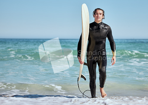 Image of Portrait, man and surfer on beach, training and wet for competition, relax and summer break. Male, athlete and guy with surfboard, water or fun for fitness, practice or workout for wellness or health