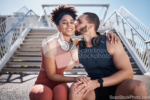 Image of Sports, love and man kissing woman on stairs in city on break from exercise workout. Motivation, health and fitness goals, couple rest and kiss with smile on morning training run together in New York