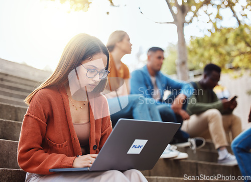 Image of University, woman sitting stairs and laptop research for school project with focus and motivation for education. College, scholarship and student on steps on campus with computer studying for exam.