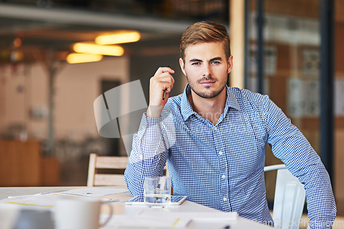 Image of Office, corporate and portrait of a young businessman working on a company project or report. Success, leadership and professional male employee or leader planning a strategy in the modern workplace.