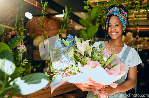 Image of Black woman with bouquet, flowers and florist in greenhouse, small business owner and smile in portrait. Happiness, nature and entrepreneur with floral arrangement, Spring and vision with leadership