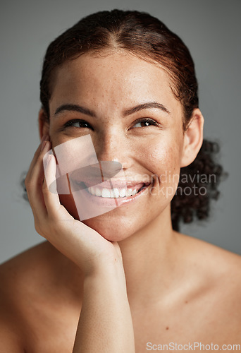 Image of Face, beauty and skincare of woman in studio isolated on a gray background. Thinking, makeup cosmetics and happy female model satisfied with spa facial treatment for glowing, healthy or flawless skin