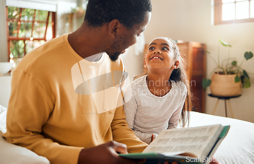 Image of Happy, child and father reading a book for education, learning and information in their family home. Love, smile and African dad with a girl in the bedroom for a story, bonding and quality time