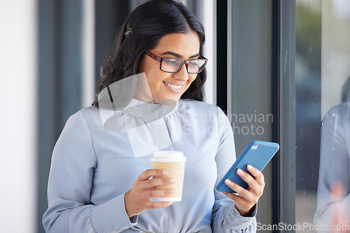 Image of Coffee, phone and business woman on a break in the office networking on social media, mobile app or internet. Happy, smile and professional employee reading a blog on her cellphone in the workplace.