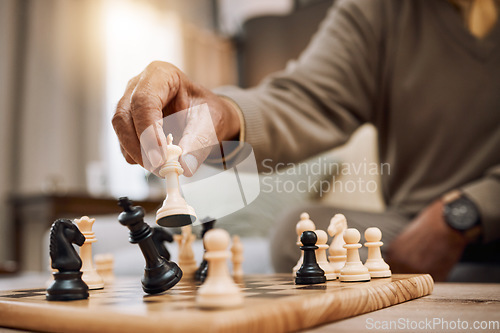 Image of Man, playing hands and chess king in house, home living room or apartment in winner strategy, checkmate or board game success. Zoom, chessboard and winning pawn in thinking mind challenge or activity
