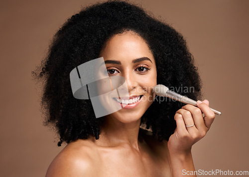 Image of Beauty, face portrait and black woman with makeup brush in studio isolated on a brown background. Cosmetics tool, skincare and happy female model with product to apply foundation for facial wellness.