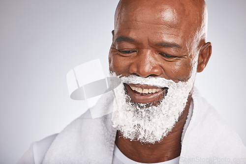 Image of Face, shaving cream and happy black man with smile on beard, skincare treatment on grey background. Health, mock up and facial hair, mature man morning shave routine with space for product placement.