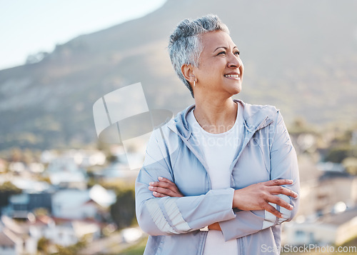 Image of Elderly woman, thinking and outdoor fitness exercise for calm vision, relax freedom and sports workout in nature. Cardio lifestyle, senior person and athlete smile on mountain top with crossed arms