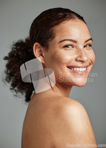 Image of Portrait, face and skin with a model black woman in studio on a gray background for beauty or skincare. Facial, wellness and natural with an attractive young female posing to promote cosmetics