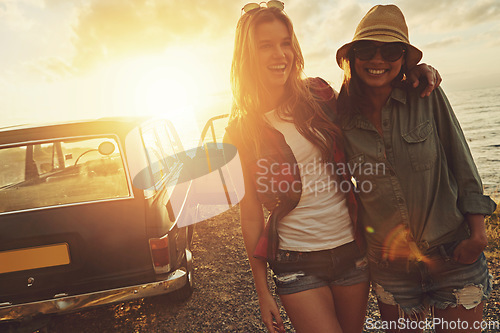 Image of Friends, travel and smile for sunset road trip adventure, journey or vacation by the ocean. Portrait of woman and best friend smiling for traveling, freedom or holiday with lens flare by the beach