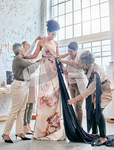 Image of Designer women, help model and fitting dress, design and teamwork for runway fashion vision in workshop. Happy creative team, woman collaboration and test fabric with diversity, goals or helping hand