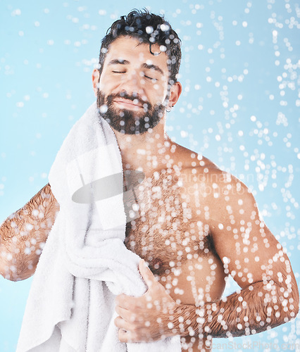 Image of Clean, man with towel and beauty, body hygiene with bokeh overlay and grooming against blue background. Skincare with shower and smile, clean cosmetic care and cotton fabric, facial and wellness