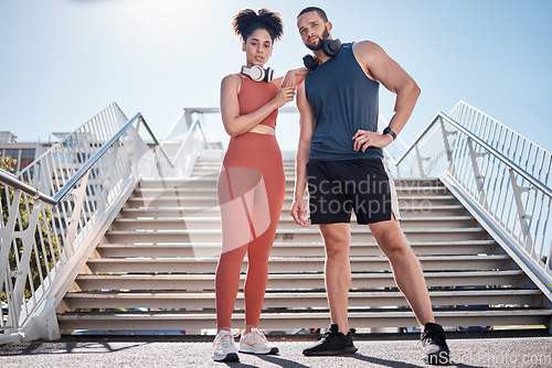 Image of Couple, city stairs and portrait for fitness with headphones, music and motivation for urban workout together. Exercise team, black couple and support for health, wellness and training in Cape Town