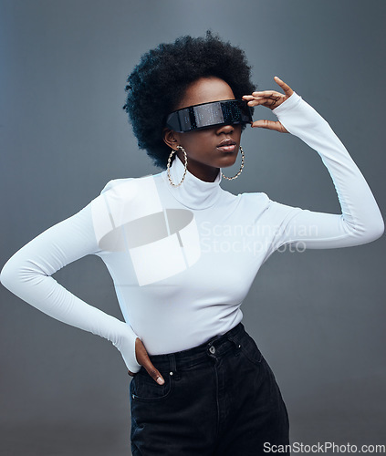 Image of Futuristic sunglasses, fashion and black woman, cyberpunk and gen z with trendy designer brand against studio background. Young model, stylish and natural curly hair with beauty and edgy style