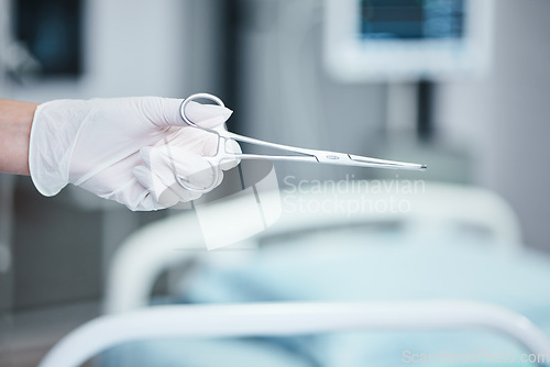Image of Scissors, surgery and doctor hand for medical tools, innovation and hospital healthcare insurance, trust and theatre background. Metal equipment, operation and surgeon or professional in a theater