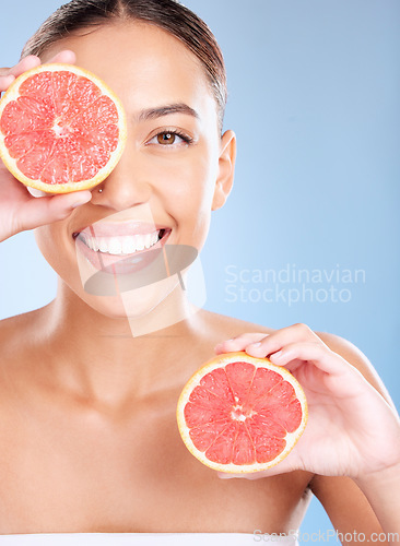 Image of Beauty, grapefruit and woman with face and natural cosmetic care, facial and glow with vegan product against studio background. Skincare, healthy skin and wellness with fruit, hands and cosmetics.