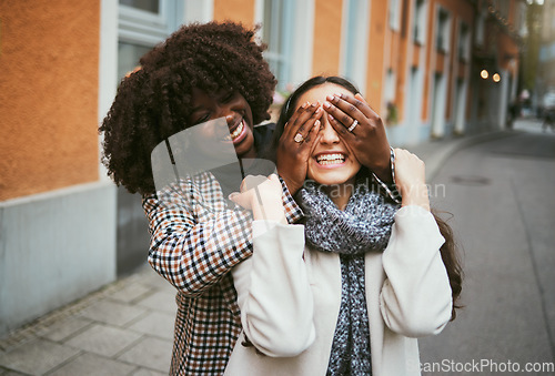 Image of Women, bonding or hands covering eyes in hide and seek, playful or comic game in New York City, road or street. Smile, happy or fun friends and surprise hand gesture in travel freedom or wow birthday