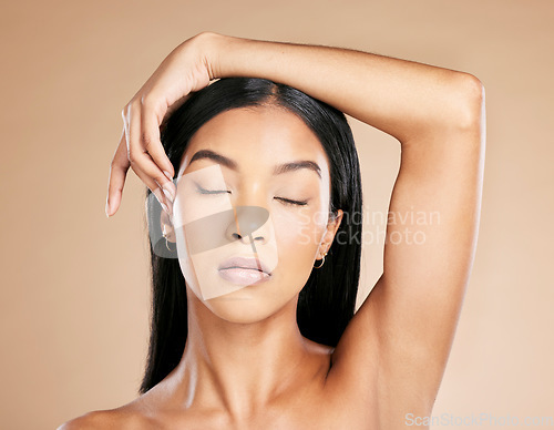 Image of Skincare, peace and face of a woman with makeup from a spa isolated on a studio background. Luxury, calm and Asian cosmetics model with zen from salon, cosmetology and beauty on a beige backdrop