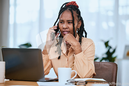 Image of African woman, laptop and smartphone call conversation for online communication or planning strategy in home office. Black woman, focus and talking on phone call for business planner with tech device