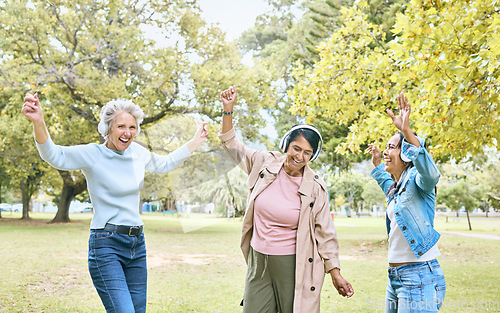 Image of Senior women, dancing or music headphones in silent disco, retirement fun or energy movement in bonding wellness. Smile, happy friends or elderly dancers listening to radio audio in nature trees park