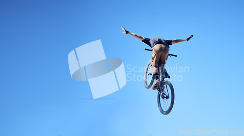 Image of Fitness, bicycle and man doing a trick in the sky for a competition, exercise or training. Sports, cycle and male athlete or cyclist doing a stunt with skill for outdoor workout or contest with bike.