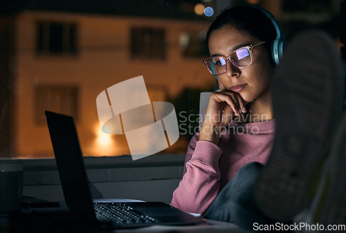 Image of Creative woman, laptop and thinking at night for deadline, project or working late at office. Business woman relaxing by desk in thought for planning on computer in evening for startup at workplace